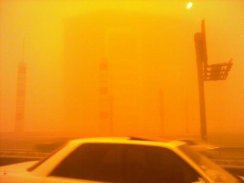 you can only make out the outline of buildings overlooking the highway