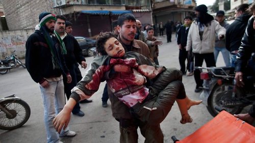 man carries Syrian boy